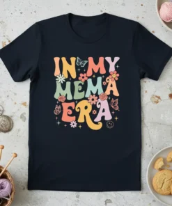 Retro "In My Mema Era" text with colorful floral and butterfly graphics on a navy t-shirt