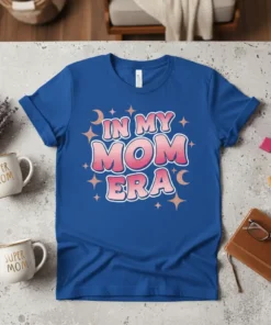 In My Mom Era text design with pink gradient letters and star and moon graphics on a royal blue t-shirt