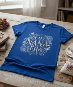 Royal blue t-shirt with "In My Nana Era" text in gold, surrounded by floral and butterfly graphics