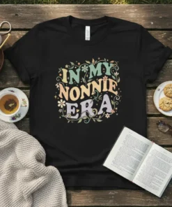 In My Nonnie Era text design with floral and star accents on a black t-shirt