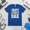 In My Nursing School Era text design with syringe, books, and nurse cap graphics on a blue t-shirt