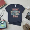 In My Nursing School Era t-shirt with vintage font, syringe, and nurse cap graphic