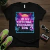 T-shirt design with text "In My Official Teenager Era" in neon retro style, featuring palm trees, sunset, disco ball, and