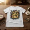 White t-shirt with "In My Oma Era" text surrounded by colorful flowers and hummingbirds, perfect for grandmothers