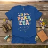Retro groovy "In My Para Era" text design with stars and flowers on a blue t-shirt
