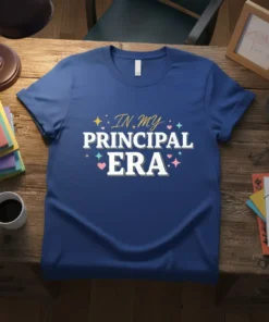 Blue t-shirt with white text "IN MY PRINCIPAL ERA" in a fun font, surrounded by colorful stars and hearts