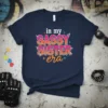 Navy t-shirt with "in my SASSY SISTER era" text in colorful, distressed lettering and star accents