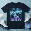 In My Skating Era text design with a figure skate graphic, snowflakes, and crystals, on a navy t-shirt