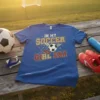 In My Soccer Girl Era t-shirt design with a soccer ball, wings, and cleats, on a blue shirt