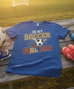 In My Soccer Girl Era t-shirt design with a soccer ball, wings, and cleats, on a blue shirt