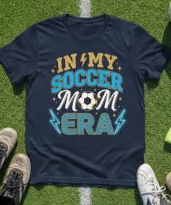 Navy t-shirt with "In My Soccer Mom Era" text and a soccer ball graphic, featuring lightning bolt accents and stars