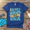 In My Swim Mom Era text with a groovy sun graphic and waves on a blue t-shirt