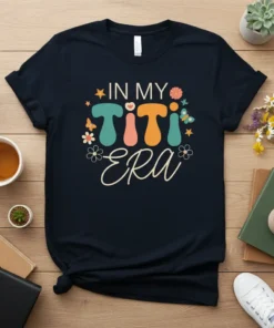 In My Titi Era text in retro font with colorful letters and floral accents on a navy t-shirt