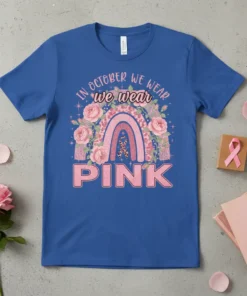 Blue t-shirt with "In October We Wear Pink" text, rainbow, roses, and pink ribbon graphic for breast cancer awareness