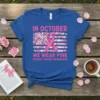 Blue t-shirt design with pink text "In October We Wear Pink Breast Cancer Awareness" and a floral American flag with