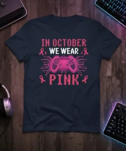 In October We Wear Pink t-shirt design featuring a pink video game controller and circuit board pattern, promoting breast cancer