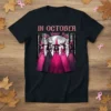 In October We Wear Pink t-shirt design with five witches in pink dresses and hats, supporting breast cancer awareness