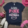 Navy t-shirt with "In October WEAR PINK And Watch FOOTBALL" text, pink ribbon, and football graphic