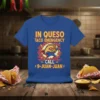 Taco superhero graphic with text "IN QUESO TACO EMERGENCY CALL 9-JUAN-JUAN" on a blue t-shirt