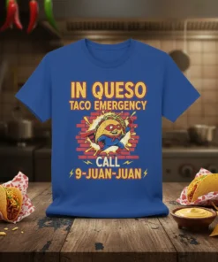 Taco superhero graphic with text "IN QUESO TACO EMERGENCY CALL 9-JUAN-JUAN" on a blue t-shirt
