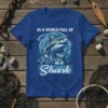 Shark graphic t-shirt with text "In A World Full Of Fish Be A Shark" in bold white font