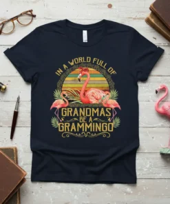 In a World Full of Grandmas Be a Grammingo text with flamingo graphic on navy t-shirt