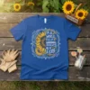 T-shirt with text "In A World Full of Grandmas, Be A Lolly" and a sunflower graphic, blue t-shirt design