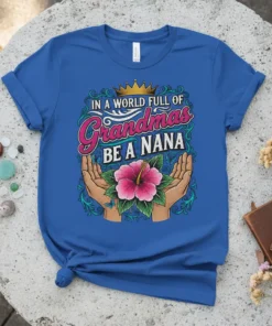 In A World Full Of Grandmas Be A Nana text with crown and hibiscus flower on a blue t-shirt