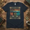 Inspirational quote t-shirt: "In A World Where You Can Be Anything Be Kind" in retro font and art deco border