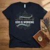 Christian t-shirt with the text "in the waiting GOD IS WORKING" in a celestial design