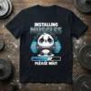 Installing Muscles Please Wait text with cute panda lifting barbell, progress bar, and blue fire graphic on a black t-shirt