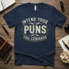 Intend Your PUNS YOU COWARDS text design on a navy t-shirt, featuring vintage-style typography and decorative elements