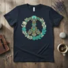 Intricate peace symbol design with floral and Celtic knot elements on a navy t-shirt