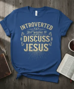Christian t-shirt with "Introverted But Willing To Discuss Jesus" text in ornate golden font on a blue shirt