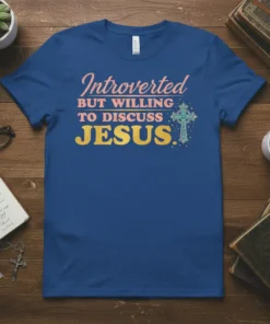 Introverted But Willing to Discuss Jesus T-Shirt with gold glitter text and a decorative cross graphic