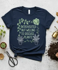 Navy blue t-shirt with the text "INTROVERTED BUT WILLING TO DISCUSS PLANTS." in green, surrounded by vine graphics