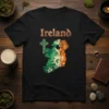 Black t-shirt with an artistic map of Ireland filled with Celtic knotwork in green, white, and orange, and a Celtic