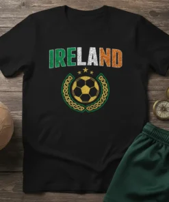 Black t-shirt with "IRELAND" text in green, white, and orange, featuring a distressed soccer ball within a Celtic knot design