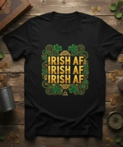Black t-shirt with "IRISH AF IRISH AF IRISH AF" repeated in gold lettering, surrounded by shamrocks and Celtic knot designs