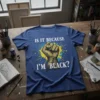 Is It Because I'm Black? quote with a golden fist graphic on a blue t-shirt