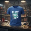 Blue t-shirt with white and green "Is My Bike Ok?" text, designed for cyclists and mechanics