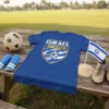 Blue t-shirt with "ISRAEL SOCCER" text in white and gold, featuring a soccer ball graphic and distressed shield design