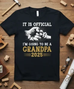 It is official I'm going to be a grandpa 2025 text with a fist bump graphic on a black t-shirt
