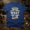 Steampunk t-shirt design with the quote "IT IS WHAT IT IS" in distressed vintage lettering, featuring a hot air balloon