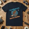 It Is Whats It Is And It's Autism t-shirt with a frog riding a scooter design in neon blue and