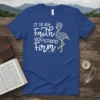 Blue t-shirt with white and gold text "IT IS BY Faith YOU STAND Firm" and a decorative flamingo graphic. Includes