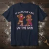 Gingerbread man t-shirt with text "IT PUTS THE ICING ON THE SKIN" in a creepy font and spooky gingerbread characters
