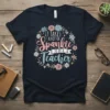 It Takes A Lot Of Sparkle To Be A Teacher quote on a navy t-shirt with floral wreath design