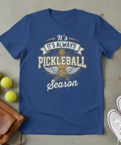 It's Always Pickleball Season text with pickleball graphics and wings on a blue t-shirt