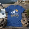 T-shirt featuring the quote "It's Another Half Mile Or So" with a mountain sunset graphic and footprints, designed for hikers